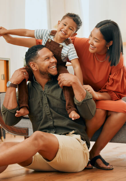 family smiling inside home